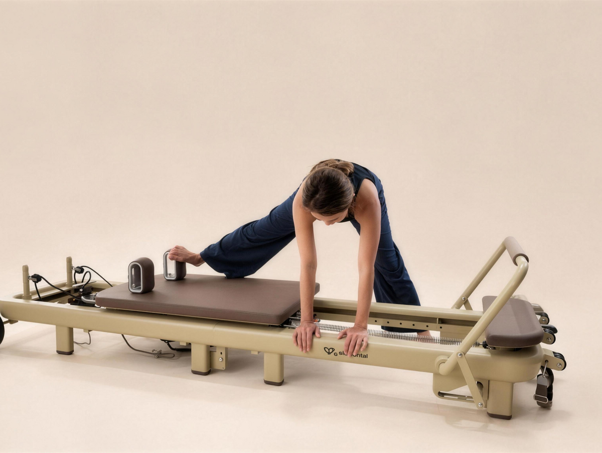 Pilates practitioner exploring a side-reaching movement over the Elemental TerraFold reformer