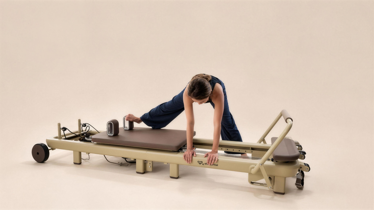 Pilates practitioner exploring a side-reaching movement over the Elemental TerraFold reformer